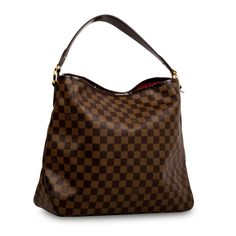 That perfect, practical, stylish and spacious tote you’ve been looking your whole life for? Look no further, hun. Crafted from the brand’s signature Damier Ebene canvas, Louis Vuitton presents the Graceful hobo bag – the extra-roomy yet lightweight bag you won’t be able to live without. Whether you’re travelling, packing an overnight bag, carrying your laptop and binders to work, or just enjoy bringing your whole entire world with you wherever you go, then this is the bag for you. The perfect accessory to compliment any outfit from casual to smart, the Graceful is the ideal companion to accompany you wherever you go. A well-worthy addition to any luxury handbag collection, the LV Graceful is a true must-have. SPL Exterior  Damier Evene canvas Gold tone hardware Brown leather shoulder strap Louis Vuitton Presents, Handbag Collection, Lightweight Bag, Timeless Handbag, Damier Ebene, Overnight Bag, Binders, Exclusive Bag, Leather Mini