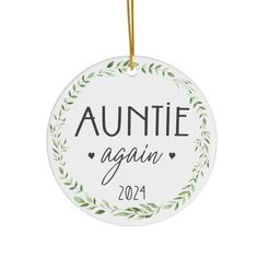 an ornament that says,'auntie again'in black and white