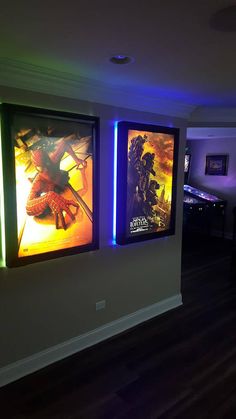 two movie posters on the wall in a dark room