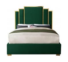 a bed with a green headboard and white sheets