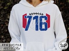 a woman wearing a white hoodie with a football on it and the number seventy