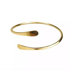 Add some sass to your bangle stack with our Brass Coil Bangle. It features a simple design, with rounded flares on both ends. Bangles sold separately.