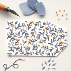 paper cut out to look like an ornament with scissors and beads around it