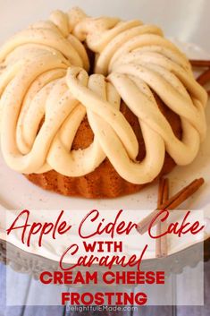 an apple cider cake with caramel cream cheese frosting on a white plate