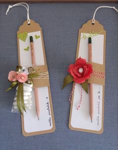 two wooden clothes pins with flowers on them