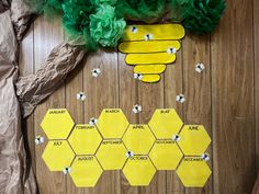 a wooden table topped with lots of yellow pieces of paper next to a bunch of flowers