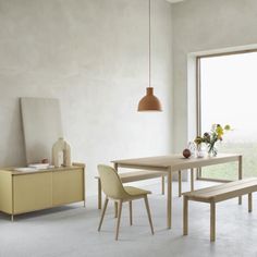 a dining room table with two chairs and a bench in front of a large window