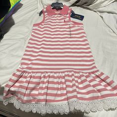 Polo Ralph Lauren 6x Faded Red White Striped Collared Drop Waist Dress With Ruffled Hemline And Lace Trim In A Great Cotton Pique Material Much Like The Signature Polo Shirts . Hemline Has A Sweet Adorable Ruffle With Lace Trim That Is About 1.5 “ In Length . This Item Is Preppy Coastal Summer Fall Spring Vacation Camp Wedding Contemporary Farmhouse Cruise Beach Nwt And Perfect Unworn Free Of Smells Rips Stains White Polo Dress, Wedding Contemporary, Anchor Dress, Preppy Coastal, Hand Smocked Dress, Ralph Lauren Baby Girl, Blue Floral Print Dress, Coastal Summer, Pink Sleeveless Dress