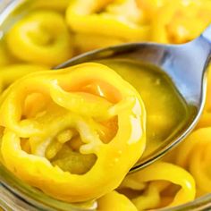 a spoon with some yellow peppers in it