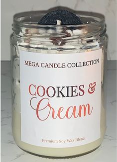 cookies and cream in a glass jar on a marble countertop next to a candle