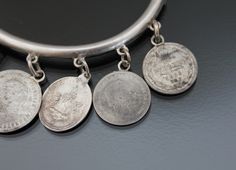 "1890's, Austria-Hungary. Love tokens hinged bangle bracelet. MADE OF: silver 750 - 835, stone tested. CONDITION: Very good antique condition. Few micro dents. Ages patina. Push button box closure works fine. MEASUREMENTS: Inner circumference: 7 1/16\" (18cm). Width on back: 3/16\" (5mm). Weight: 19,8g. * * * All our items are packed in gift boxes, easy to check of content and re-pack. If you wish something special, please let us know. * * * LAYAWAYS: All items can be put on layaway, max 4 month Historical Silver Jewelry As A Gift, Silver Jewelry With Vintage Charm For Commemoration, Historical Silver Medallion Jewelry, Victorian Sterling Silver Bangle Bracelet, Silver Vintage Charm Jewelry For Commemoration, Victorian Round Hinged Bangle, Victorian Hallmarked Jewelry For Collecting, Victorian Adjustable Bangle - Gift, Victorian Stamped Collectible Jewelry