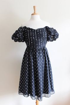 "Vintage 1980s Gigi's Closette party dress in black and white polka dot sheer black lightweight woven fabric with ruched bodice, low slight v-neckline, off the shoulder short puffy ruched sheer sleeves with elastic, boning in bodice for structure, waist seam, full gathered skirt, full lining, and back zipper. Great vintage condition. (please note - dress zips all the way up it is just too small for the dress form) full garment measurements: bust: 31\" waist: 23.5\" hip: free length (underarm to Polka Dot Ruched Party Dress, Polka Dot Ruched Dress For Party, Blue Floral Top, Most Beautiful Dresses, Ruched Bodice, All The Way Up, Gathered Skirt, Vintage Shorts, Black Polka Dot