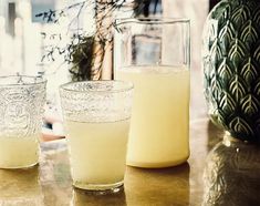 three glasses sitting on top of a table next to each other