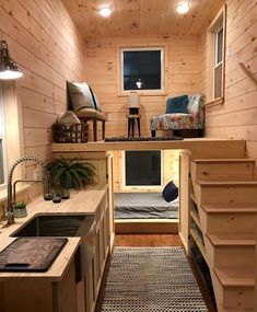 the interior of a tiny cabin with stairs