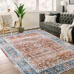 a living room with a couch, chair and rug