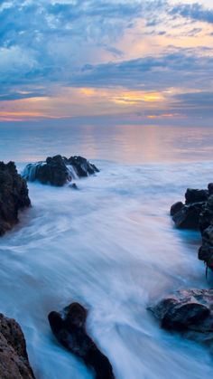 the ocean with waves coming in to shore at sunset time - stock photo - images