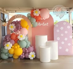 balloons and vases are on display in front of a sign that says balloon art