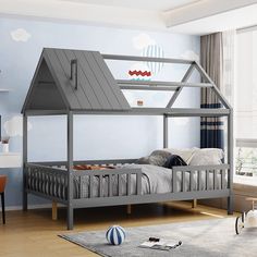 a child's bed with a house shaped roof