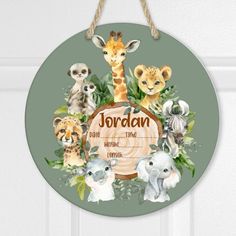 a round wooden sign with an image of animals and the name jordan on it, hanging from a door