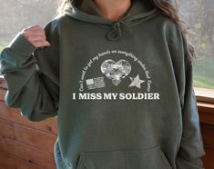 Snuggle up in style with this I Miss My Soldier Hoodie! Featuring a comfy and cozy design, this hoodie is perfect for showing off your pride and support for your partner in the Army. Get your hands on this must-have hoodie and show the world your love and loyalty! This unisex heavy blend hooded sweatshirt is relaxation itself. Made with a thick blend of cotton and polyester, it feels plush, soft and warm, a perfect choice for any cold day. The color-matched drawcord and the double-lined hood add a stylish flair and durability that tie everything together. This Hoodie is available in 5 colors: Black, Sport Grey, Dark Chocolate, Military Green and Dark Heather. This hoodie sweatshirt is custom printed when ordered so returns are not accepted. Thank you for supporting our small business. Soldier Girlfriend, Military Girlfriend Army, Soldier Wife, Navy Girlfriend, Deployment Gifts, Military Girlfriend, Navy Wife, Cozy Design, Army Girlfriend