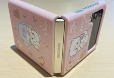 a pink case with elephants on it sitting on a table