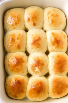 a casserole dish filled with rolls covered in cheese