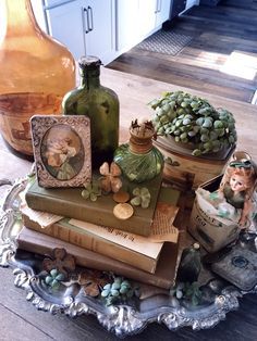 there are many vases and books on the table in this room, including one that is decorated with succulents