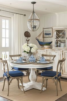 a dining room table with blue and white plates on it's centerpieces