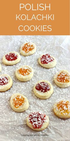 polish kolachki cookies with powdered sugar and jelly in the middle on a baking sheet