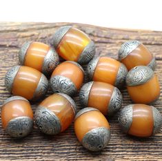 Tibet faux amber beads with engraved silver ends, Vintage Copal Beads, oval shape approx. 30 mm x 22 mm, opaque resin, Holes approx. 1 mm. You can find more beads of this type here: https://www.etsy.com/de/listing/1681576747/tibet-faux-amber-perlen-mit-gravierten Oval Carved Beads For Gifts, Amber Oval Beads, Gems, And Cabochons For Gifts, Amber Oval Beads Gems And Cabochons For Gifts, Polished Oval Amber Beads, Amber Beads, Silver Engraving, Tibet, Oval Shape, Amber