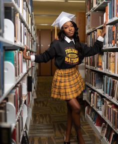 a woman in a skirt and cap is posing for the camera with bookshelves behind her