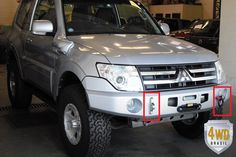 a silver pick up truck parked in a garage