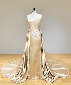 a dress on a mannequin in front of a white wall and wooden floor