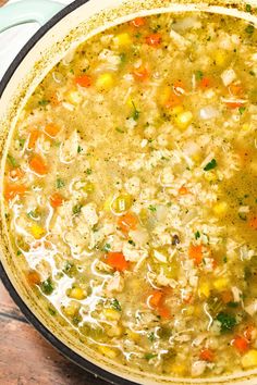 a pot filled with soup sitting on top of a wooden table