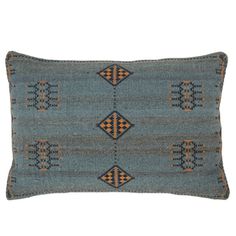 a blue pillow with orange and black designs on it