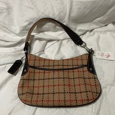 Coach Brown Leather Accents With Tan Plaid Wool With Red And Brown Stripes Through The Plaid . The Tan Is The Perfect Tan Shade . Deep Chocolate Brown Leather . This Purse Is Nwt And In Perfect Condition Free Of Rips Stains Holes Or Smells. Retro Beige Bag With Zipper Closure, Vintage Bags With Zipper Closure For Fall, Retro Beige Shoulder Bag With Zipper Closure, Fall Coach Shoulder Bag With Zipper Pocket, Vintage Beige Shoulder Bag With Zipper Closure, Coach Bags With Leather Trim For Fall, Coach Bag With Leather Trim For Fall, Coach Beige Bag With Snap Closure, Beige Coach Bag With Snap Closure