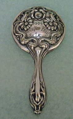 an ornate silver spoon on a green surface with the words,'i love you'written in it