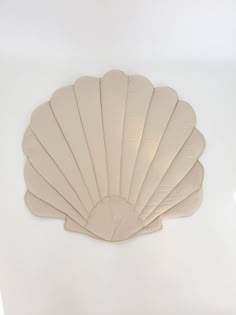 an image of a shell shaped object on the wall that looks like it's made out of paper