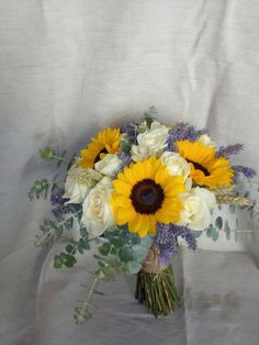 a bouquet of sunflowers and white roses