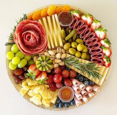 a platter filled with different types of food and condiments on top of it