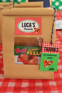 there is a box that has some food in it on the table with a red and white checkered tablecloth