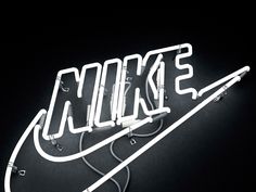 a neon sign with the word nike on it's side and wires attached to it