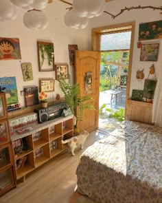 a bedroom with a bed, bookshelf and lots of pictures on the wall