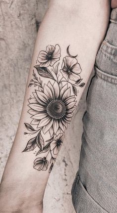 a woman's arm with a sunflower tattoo on it