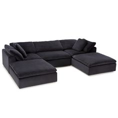 a black sectional couch with pillows on it