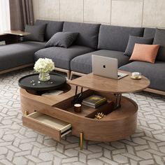 a living room filled with furniture and a laptop computer on top of a coffee table