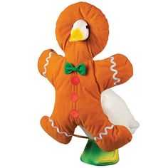 an orange stuffed animal with a green bow tie on it's head and legs