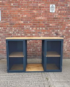 two metal and wood shelves on the side of a brick wall