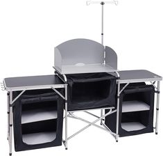 an outdoor table with two folding chairs and a grill on it's side, in front of a white background