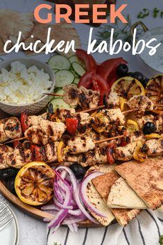 greek chicken kabobs on a plate with vegetables and pita bread